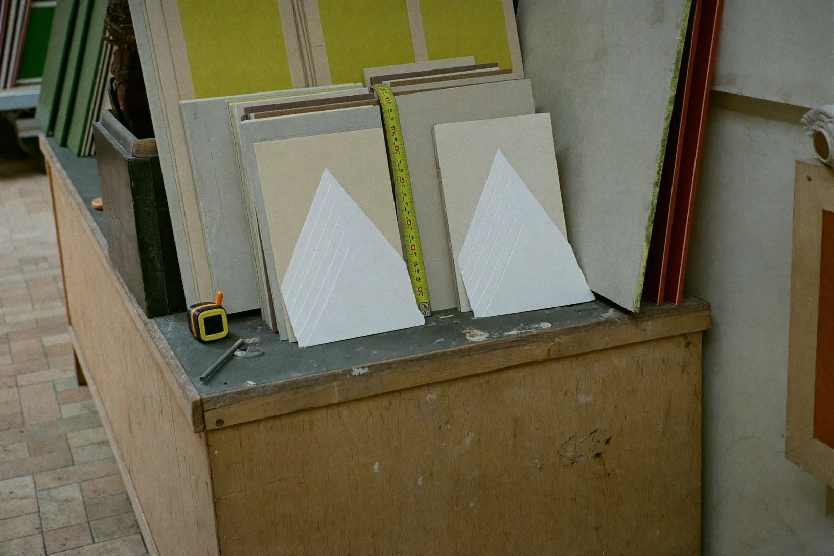 Close detail of framing tools and v-nails on a sawdust-dusted workbench